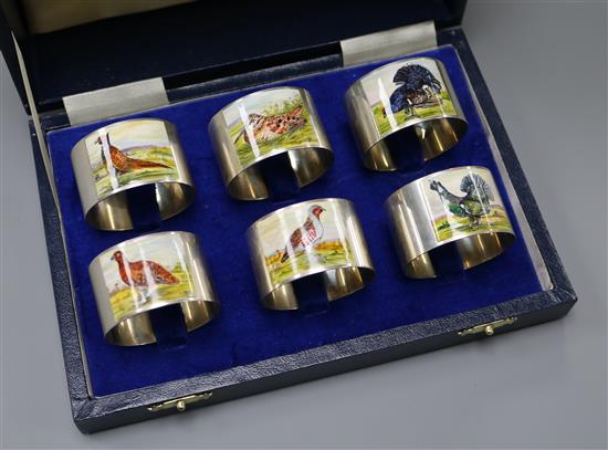 A modern cased set of six silver and enamel game bird napkin rings, W.I. Broadway & Co, Birmingham, 1993.